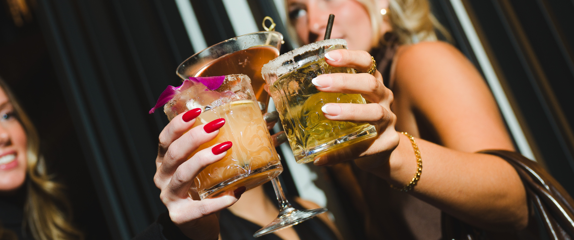 Two guests toasting cocktails at Wildflower Social